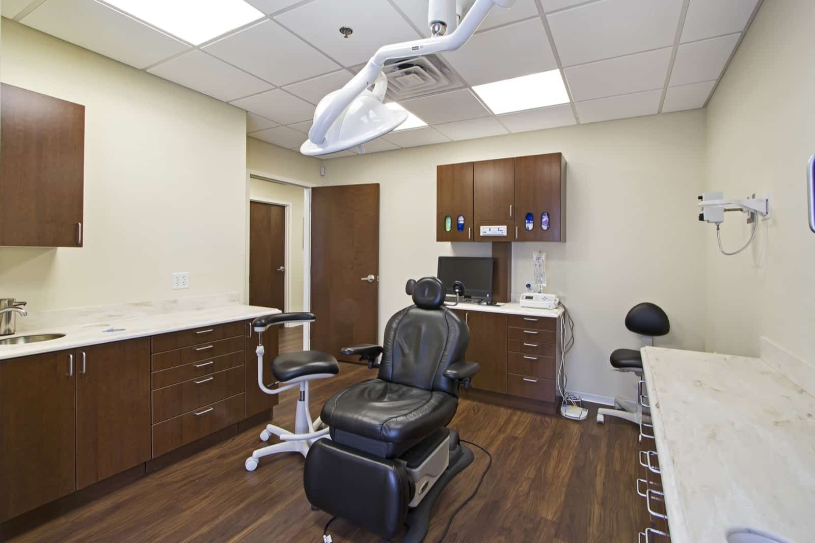 Treatment room with surgical chair, monitoring equipment, and procedure lighting