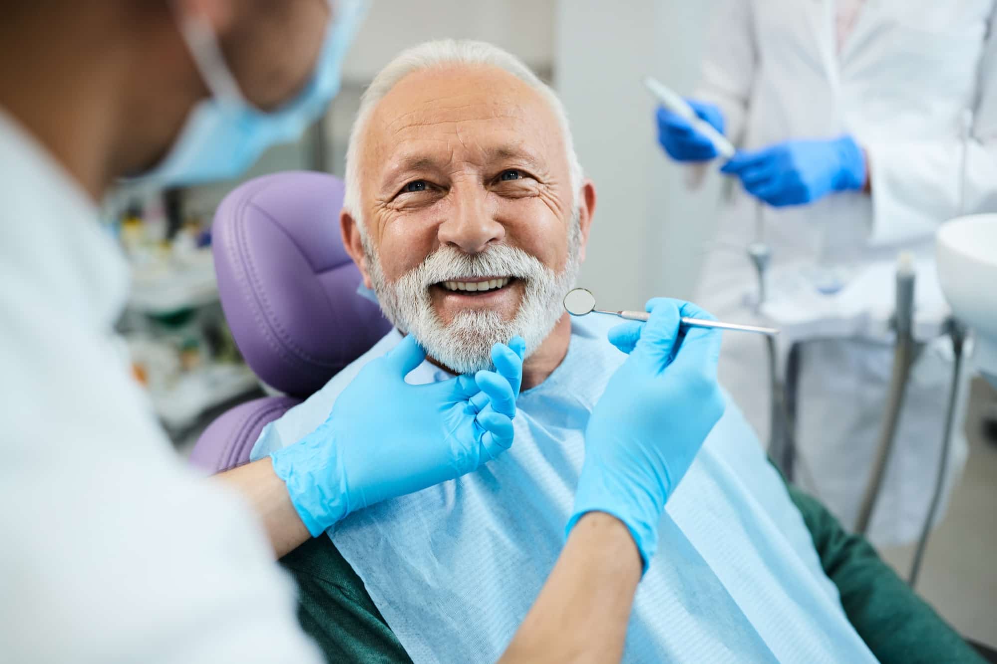 Older patient smiling in a dental chair