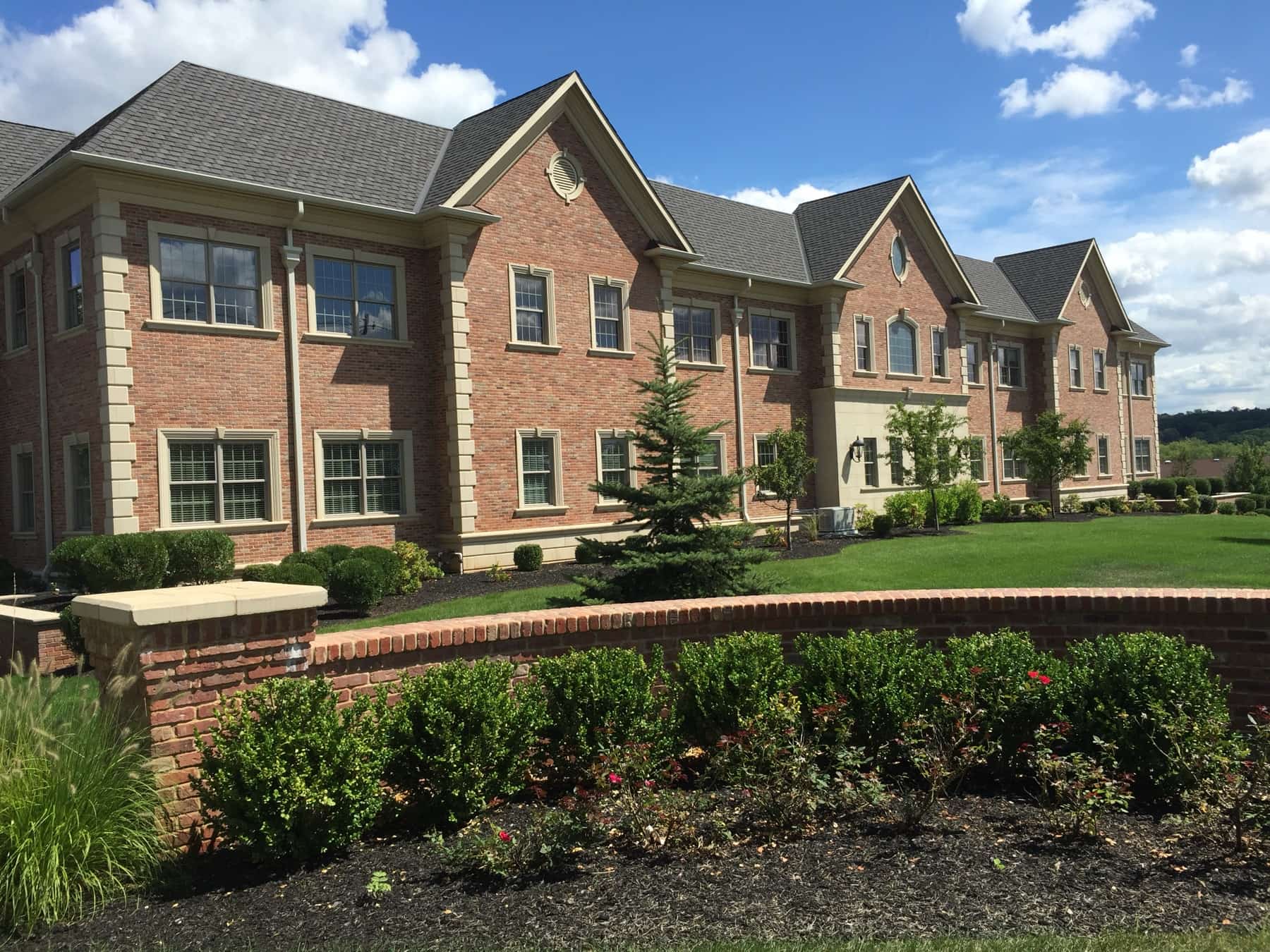 Brick professional building that houses the Warren Oral Surgery office, with landscaped entrance